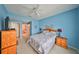 Serene bedroom with blue walls, ceiling fan, and an ensuite bathroom at 2112 Acadia Greens Dr # 62, Sun City Center, FL 33573