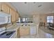 Open kitchen with a breakfast bar, white appliances and views to living spaces at 2112 Acadia Greens Dr # 62, Sun City Center, FL 33573