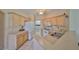 Bright kitchen featuring white appliances, light wood cabinetry, and tile flooring at 2112 Acadia Greens Dr # 62, Sun City Center, FL 33573
