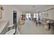 Comfortable living room with access to screened in patio, and featuring a fireplace and neutral carpeting at 2112 Acadia Greens Dr # 62, Sun City Center, FL 33573