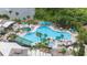 Beautiful community pool with plenty of seating, shade, and lush tropical landscaping at 2112 Acadia Greens Dr # 62, Sun City Center, FL 33573