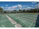 Multiple shuffleboard courts shaded by a canopy and surrounded by landscaping at 2112 Acadia Greens Dr # 62, Sun City Center, FL 33573