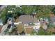 An aerial view of a well-kept property with a charming front porch and beautiful landscaping at 2125 Acorn S Pl, St Petersburg, FL 33712