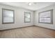 This bedroom has wood floors, white walls, and multiple windows letting in natural light at 2125 Acorn S Pl, St Petersburg, FL 33712