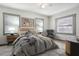 Cozy bedroom featuring a comfortable bed, stylish decor, and ample natural light through multiple windows at 2125 Acorn S Pl, St Petersburg, FL 33712