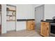 Kitchen featuring wood cabinets, granite countertops, a built in shelf, and access to another room at 2125 Acorn S Pl, St Petersburg, FL 33712