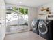 This laundry room features a sliding glass door to the exterior, and modern appliances at 2125 Acorn S Pl, St Petersburg, FL 33712