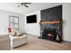 Bright living room with stone fireplace, neutral decor, and modern lighting at 2125 Acorn S Pl, St Petersburg, FL 33712