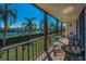 Relaxing balcony space with patio furniture and a view of the tennis court at 3021 Countryside Blvd # 24A, Clearwater, FL 33761