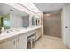 Clean bathroom with double sinks, white cabinets, and a glass enclosed shower at 3021 Countryside Blvd # 24A, Clearwater, FL 33761