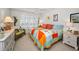 Inviting bedroom with bright quilt, shuttered windows, ceiling fan, and comfortable seating at 3021 Countryside Blvd # 24A, Clearwater, FL 33761
