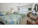Bright bedroom features two beds with matching decor and shuttered windows, ideal for guests at 3021 Countryside Blvd # 24A, Clearwater, FL 33761