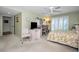 Comfortable bedroom features a floral bedspread, desk area, shuttered windows, and a ceiling fan at 3021 Countryside Blvd # 24A, Clearwater, FL 33761