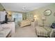 Comfortable bedroom features a floral bedspread, desk area, shuttered windows, and a ceiling fan at 3021 Countryside Blvd # 24A, Clearwater, FL 33761