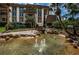 Attractive condo buildings featuring lush tropical landscaping, a small foot bridge, fountains and a winding waterway at 3021 Countryside Blvd # 24A, Clearwater, FL 33761