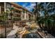 Attractive condo buildings featuring lush tropical landscaping, a small foot bridge, and a winding waterway at 3021 Countryside Blvd # 24A, Clearwater, FL 33761