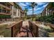Attractive condo buildings featuring lush tropical landscaping, a small foot bridge, and a winding waterway at 3021 Countryside Blvd # 24A, Clearwater, FL 33761