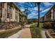 Attractive condo buildings with balconies, lush tropical landscaping, and a winding waterway on a sunny day at 3021 Countryside Blvd # 24A, Clearwater, FL 33761