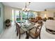 Inviting dining area with a glass table, comfortable seating, and a view of the outside patio at 3021 Countryside Blvd # 24A, Clearwater, FL 33761