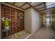 Condo entrance featuring an ornate wooden door, white wreath, and textured walls at 3021 Countryside Blvd # 24A, Clearwater, FL 33761