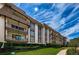 Low angle of exterior of condo complex with multiple balconies, set on well-maintained lawn at 3021 Countryside Blvd # 24A, Clearwater, FL 33761