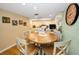 Bright eat-in kitchen features light wood cabinets, granite countertops, and a breakfast nook with a wooden table at 3021 Countryside Blvd # 24A, Clearwater, FL 33761