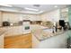 Well-lit kitchen with white cabinetry, granite countertops, and modern appliances at 3021 Countryside Blvd # 24A, Clearwater, FL 33761