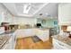 Well-lit kitchen with updated cabinets and granite countertops, plus hardwood floors at 3021 Countryside Blvd # 24A, Clearwater, FL 33761
