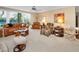 Spacious living room with large windows overlooking lush landscape and comfortable seating at 3021 Countryside Blvd # 24A, Clearwater, FL 33761