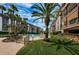 In-ground pool featuring nearby landscaping, mature trees, and multi-story buildings under partly cloudy skies at 3021 Countryside Blvd # 24A, Clearwater, FL 33761