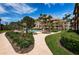 Beautiful pool area with lush landscaping and lounge chairs on a sunny day at 3021 Countryside Blvd # 24A, Clearwater, FL 33761