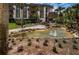 Beautifully landscaped condo community featuring a serene water feature with fountains and tropical plants at 3021 Countryside Blvd # 24A, Clearwater, FL 33761