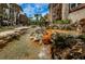 Condo community showcasing a serene water feature with rock accents, bridge and lush landscaping at 3021 Countryside Blvd # 24A, Clearwater, FL 33761