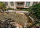 Condo community showcasing a tranquil water feature with cascading rocks and lush tropical foliage at 3021 Countryside Blvd # 24A, Clearwater, FL 33761