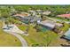 An aerial view of this home and the surrounding neighborhood with its beautiful pool and landscaping at 3323 Ringwood Mdw, Sarasota, FL 34235