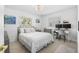 Cozy bedroom with a comfortable bed, natural light, and a functional workspace at 3323 Ringwood Mdw, Sarasota, FL 34235