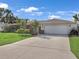 Well maintained single-story home with a wide driveway, lush landscaping and a two car garage at 3323 Ringwood Mdw, Sarasota, FL 34235