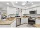 Bright kitchen with stainless steel appliances, granite countertops, and white cabinets at 3323 Ringwood Mdw, Sarasota, FL 34235