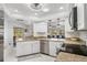 Modern kitchen with stainless steel appliances, granite countertops, and white cabinets at 3323 Ringwood Mdw, Sarasota, FL 34235