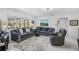 Inviting living room with comfortable seating, bright windows, and stylish decor at 3323 Ringwood Mdw, Sarasota, FL 34235