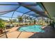 A beautiful screened-in pool area with an outdoor lounge and clear blue water awaits you at 3323 Ringwood Mdw, Sarasota, FL 34235