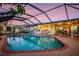 Enjoy indoor/outdoor living with a covered lanai and screened-in pool area at 3323 Ringwood Mdw, Sarasota, FL 34235