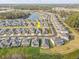 Stunning aerial view of a neighborhood featuring beautiful homes near a serene lake and lush greenery at 33886 Landsman Loop, Wesley Chapel, FL 33543