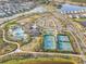 Aerial view of community amenities including pools, tennis courts, and a clubhouse at 33886 Landsman Loop, Wesley Chapel, FL 33543