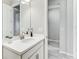 Bright bathroom featuring modern vanity and seamless mirror at 33886 Landsman Loop, Wesley Chapel, FL 33543