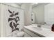 Clean bathroom with leaf-patterned shower curtain and modern sink at 33886 Landsman Loop, Wesley Chapel, FL 33543