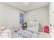 Light-filled Bedroom with crib, rocking chair, and playful decor at 33886 Landsman Loop, Wesley Chapel, FL 33543