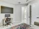 Comfortable bedroom featuring a desk, TV, and an ensuite bathroom at 33886 Landsman Loop, Wesley Chapel, FL 33543