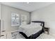 Cozy bedroom with white bedding, accent rug, and window views at 33886 Landsman Loop, Wesley Chapel, FL 33543