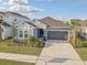 Attractive home with a two-car garage, fresh landscaping, and a paved driveway at 33886 Landsman Loop, Wesley Chapel, FL 33543